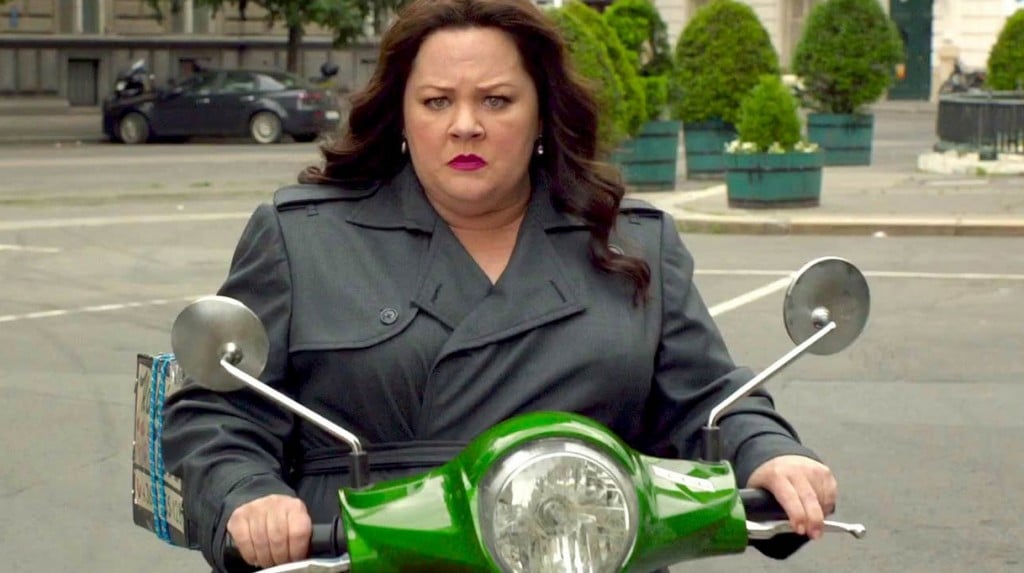 Melissa McCarthy is on a green motorcycle in Spy.