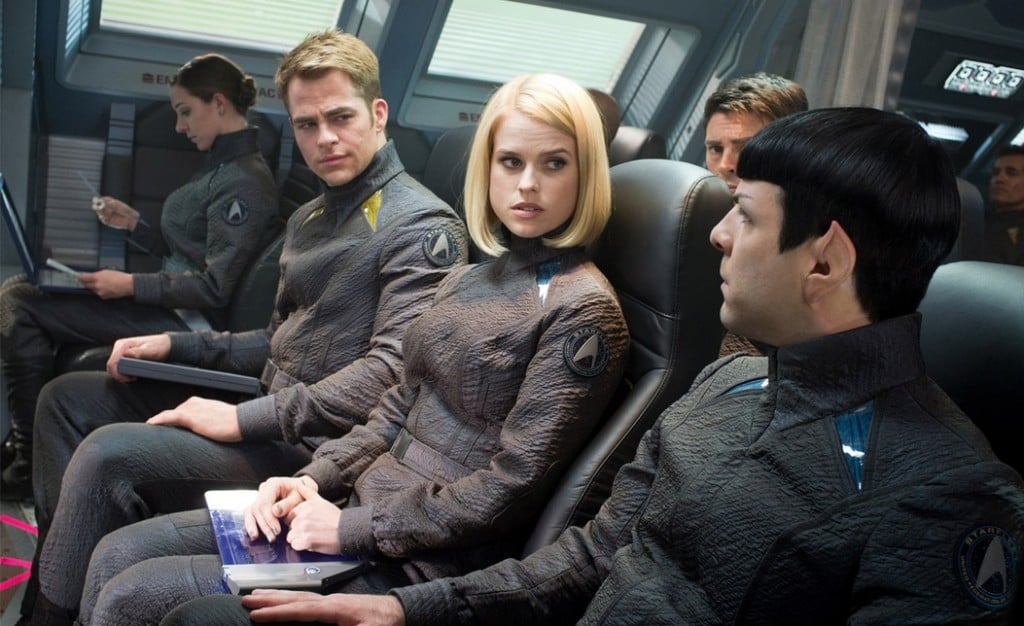 The cast of Star Trek Into Darkness are seated next to each other in a ship. The cast of Star Trek Into Darkness are seated next to each other in a ship.