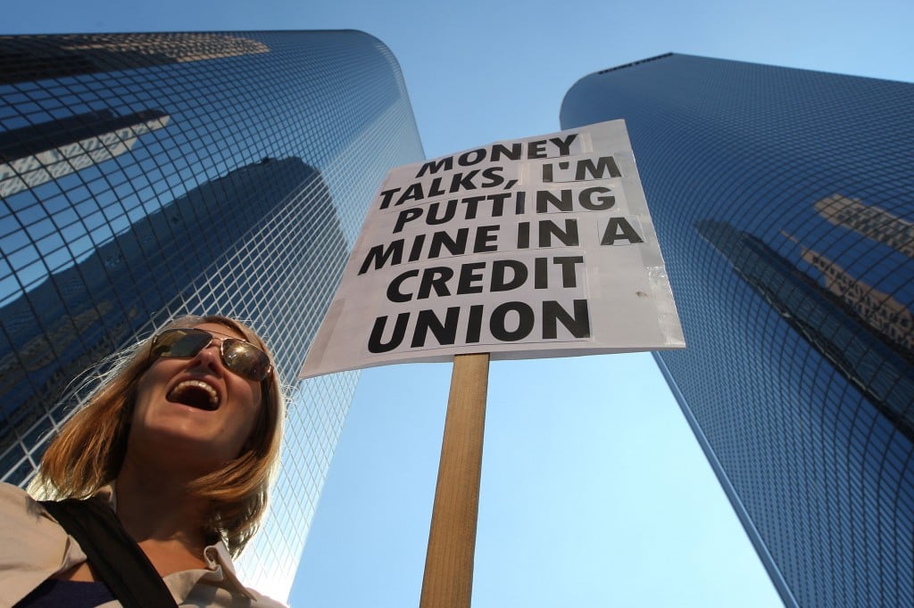 A protester supports credit unions