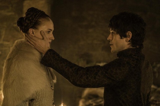 Ramsay puts his hand on Sansa's cheek as they stand facing one another