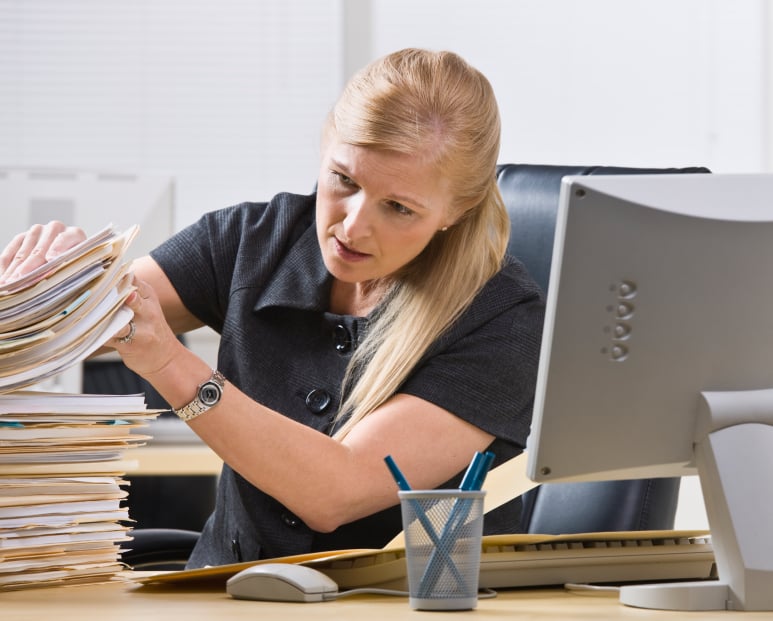 blonde woman looking through files