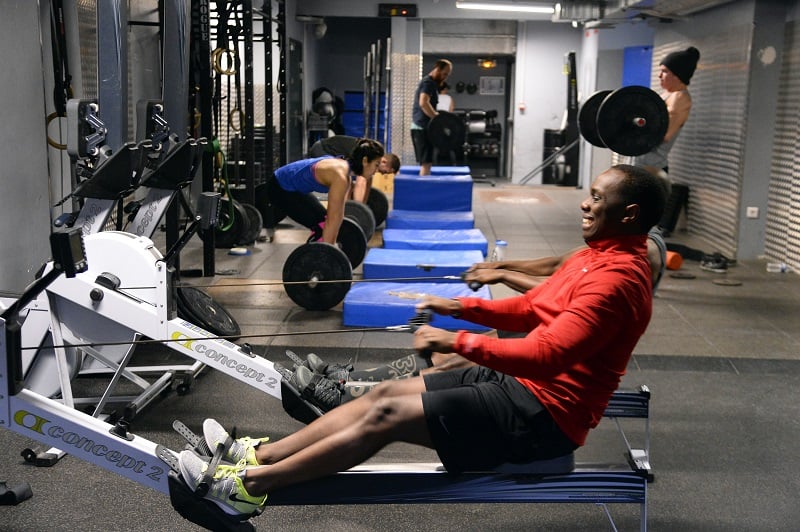 man doing rows and weight lifting