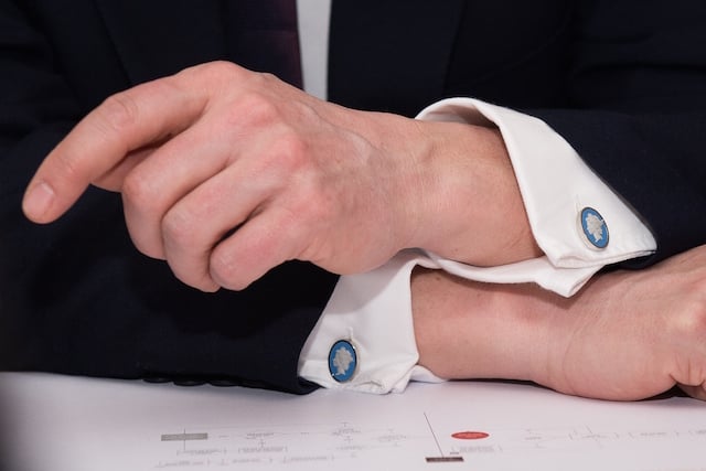 stylish man wearing cufflinks and a suit