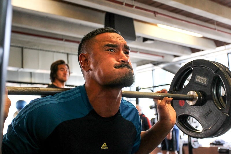 man doing heavy squats