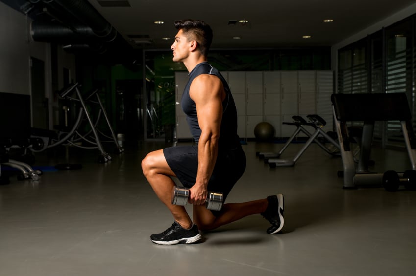 man doing a dumbbell lunge man doing a dumbbell lunge