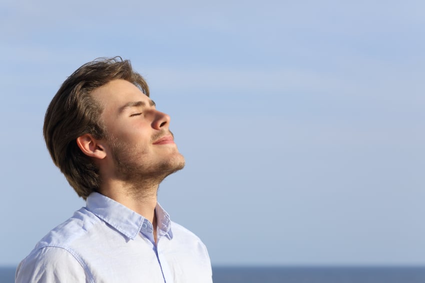 a relaxed man breathing and meditating
