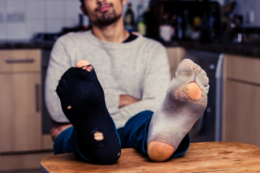 Man wearing worn out socks