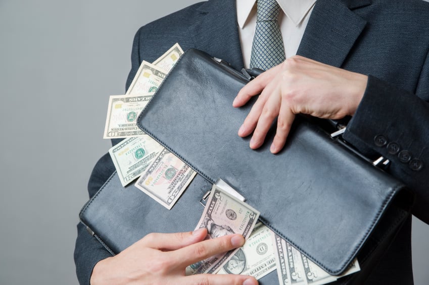 money coming out of briefcase