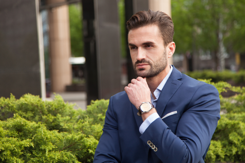 man wearing watch and suit
