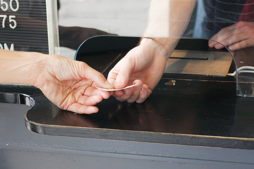 A man buying a ticket for transportation