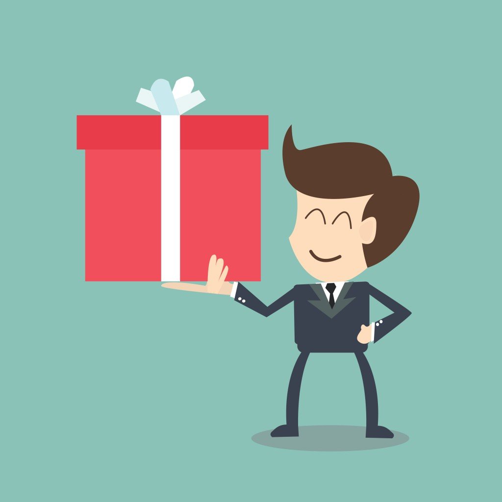 Man in suit holds up a gift
