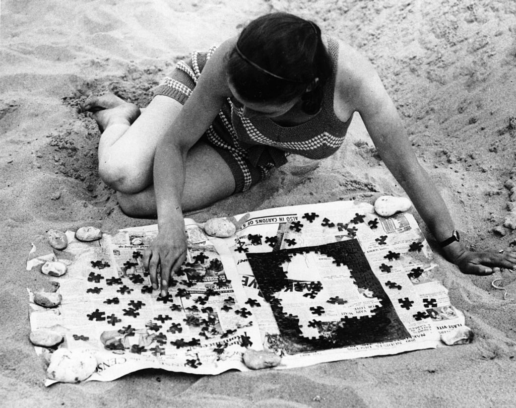 woman solving a jigsaw puzzle 