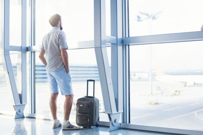 Man looking out window