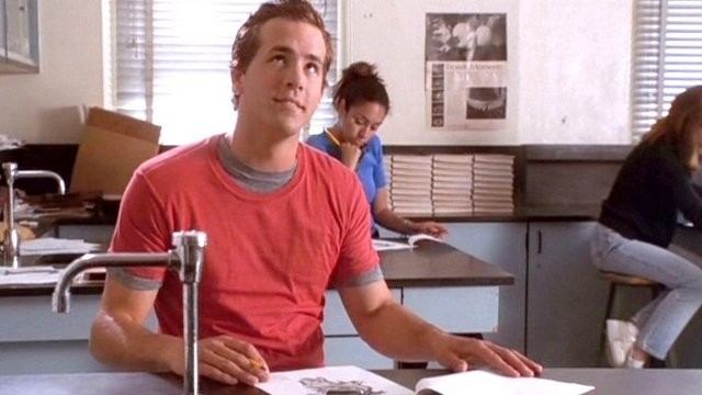 Ryan Reynolds sits at a desk. Ryan Reynolds sits at a desk.