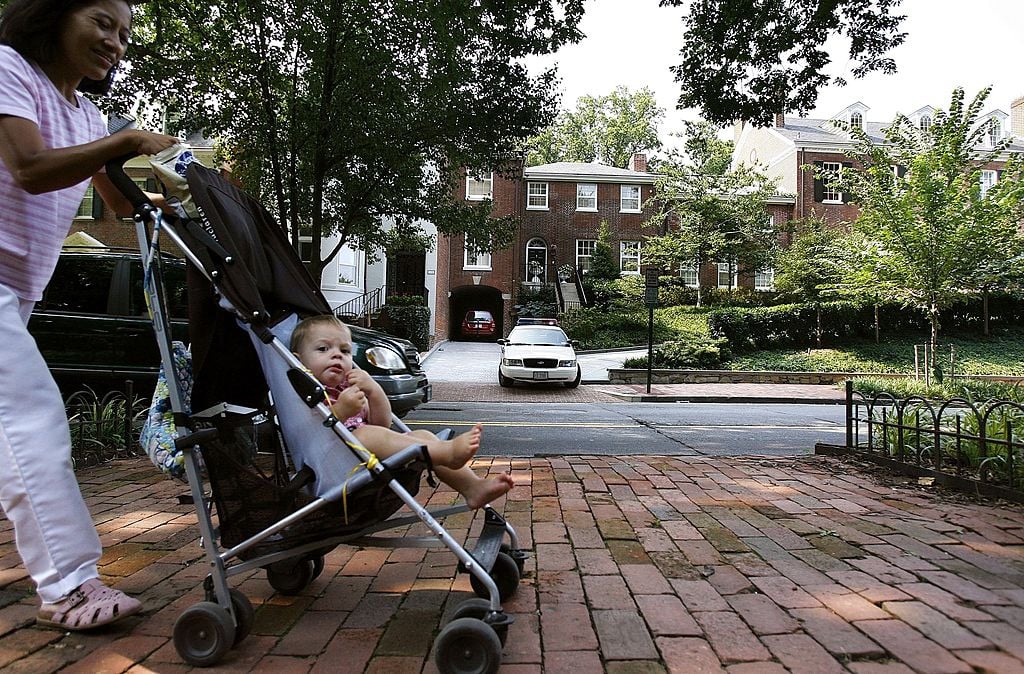 A woman walks with a baby in Washington, D.C.