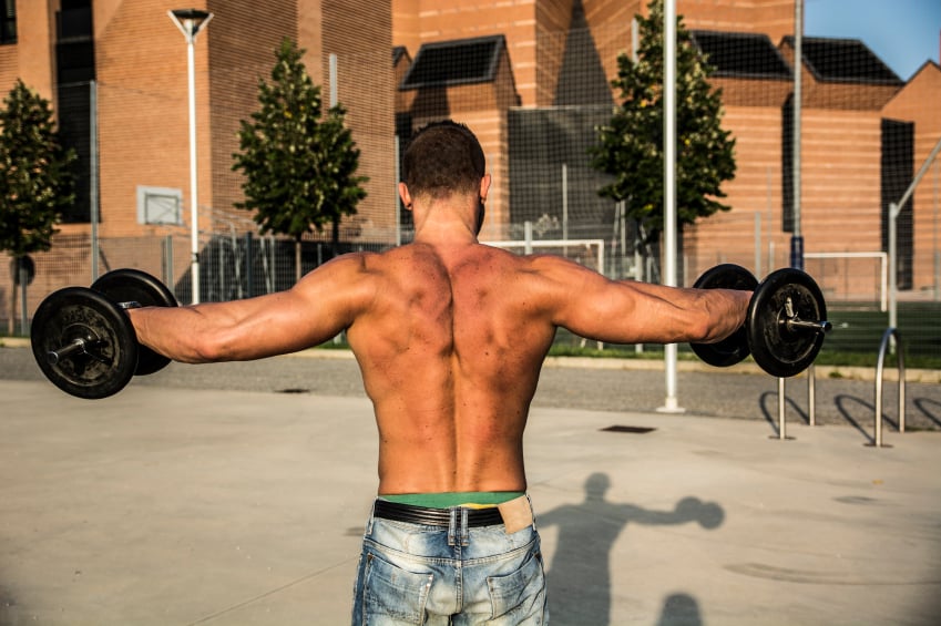 strong man doing lateral raises