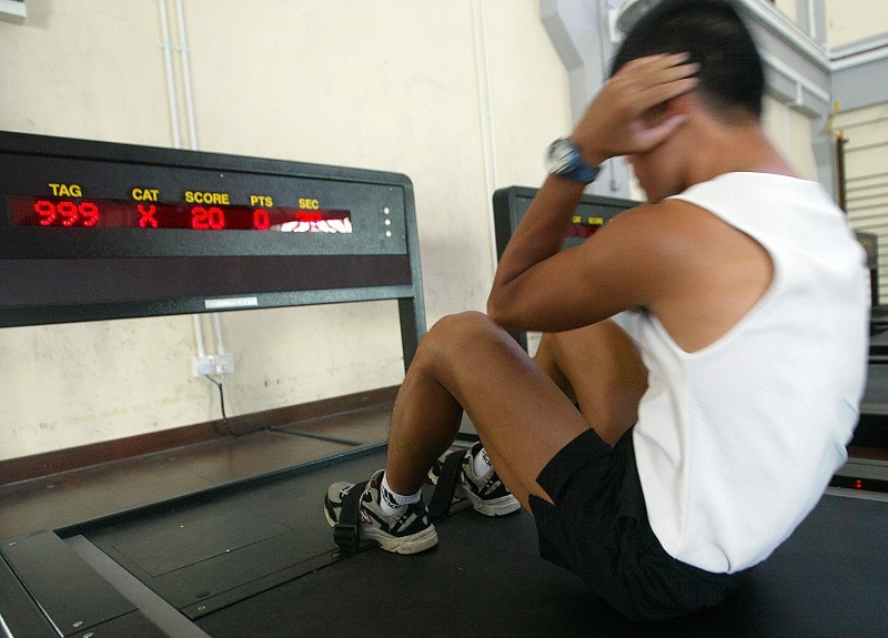 A physical trainer demonstrates how to do a sit-up