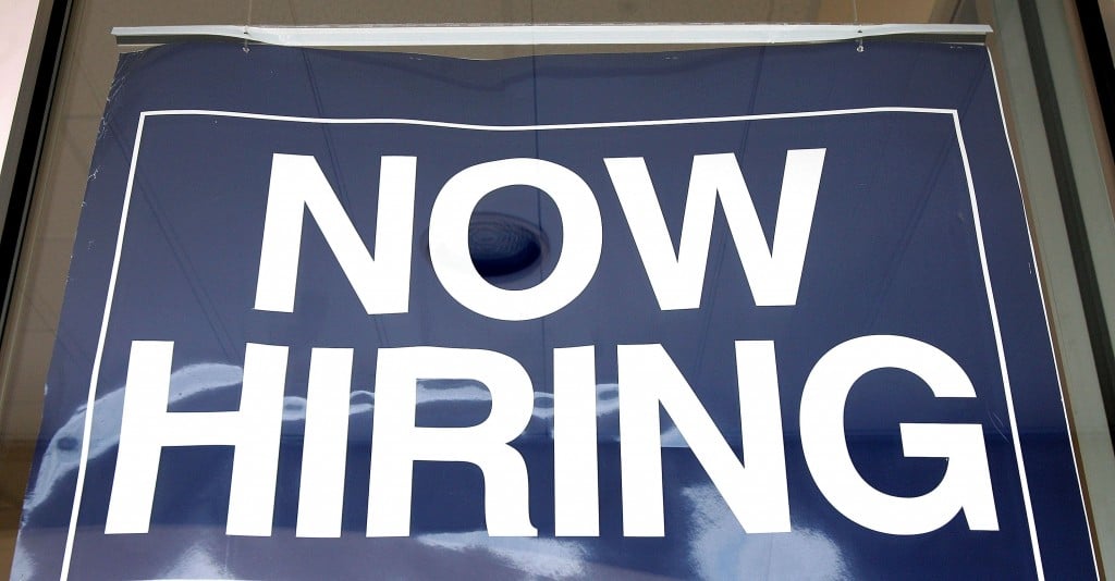 A 'now hiring' sign at a struggling business