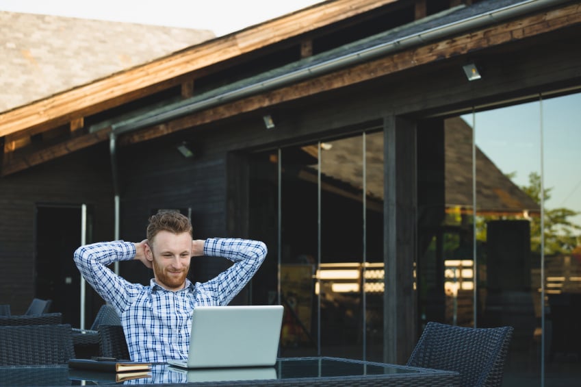 Handsome businessman working with laptop, outside