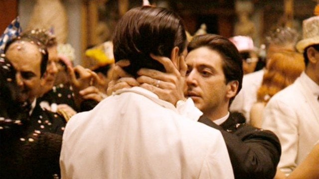 Michael Corleone holds Fredo's face at a party in The Godfather.