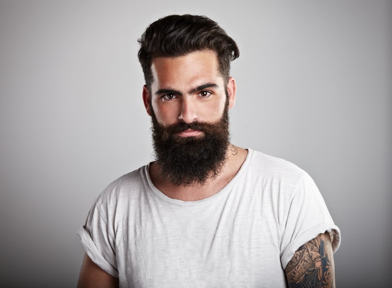 Portrait of tattooed bearded man wearing t-shirt,