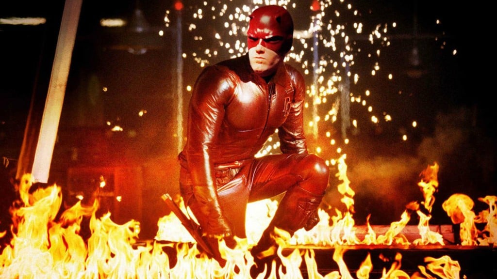 Ben Affleck as Matt Murdock in Daredevil, crouching wearing a red suit surrounded by flames Ben Affleck as Matt Murdock in Daredevil, crouching wearing a red suit surrounded by flames