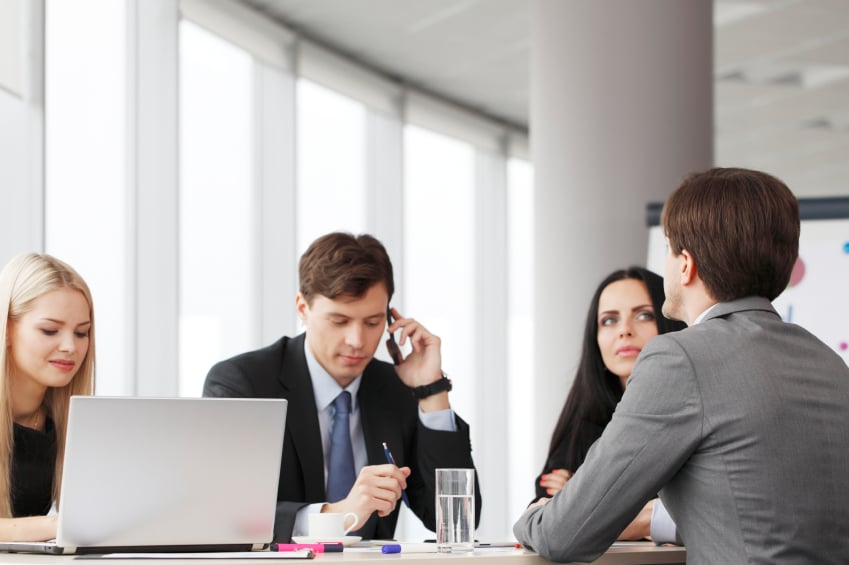 Co-workers attend a meeting