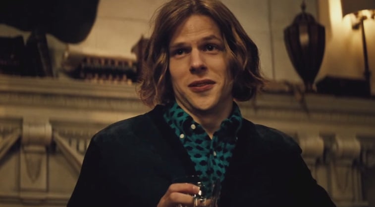 Lex Luhtor, holding a glass in his hand and wearing a collared blue shirt with black polka dots