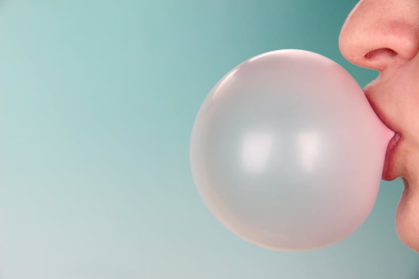 woman blowing a gum bubble woman blowing a gum bubble