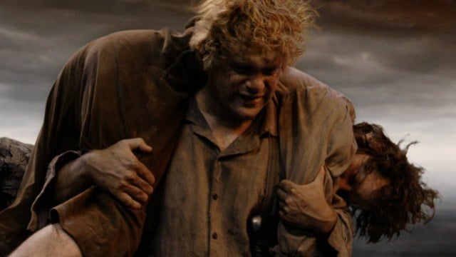 Sam carries a wounded Frodo on his shoulders. Sam carries a wounded Frodo on his shoulders.