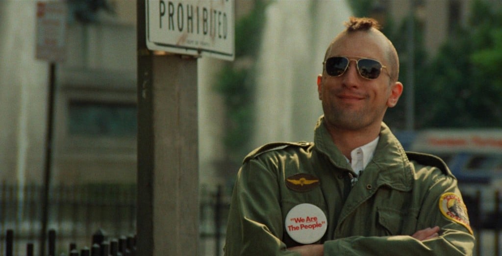 Robert De Niro smiles, wearing sunglasses and sporting a mohawk