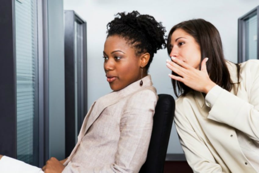 woman whispering at the office