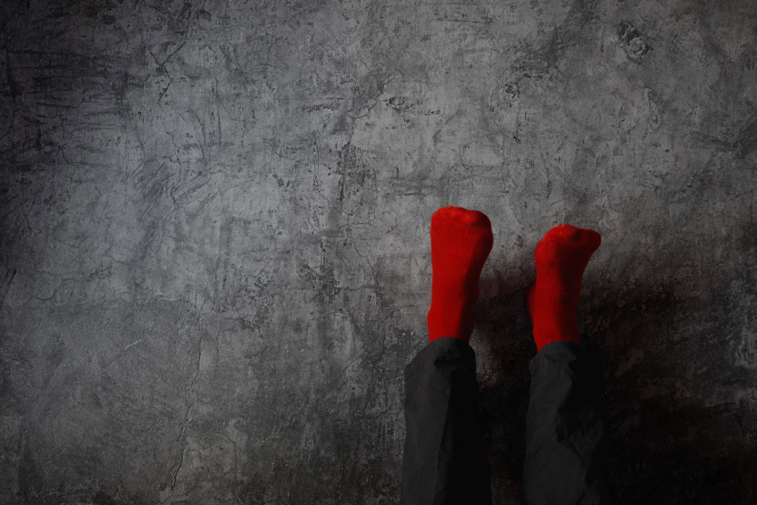 Man putting his feet against a wall Man putting his feet against a wall