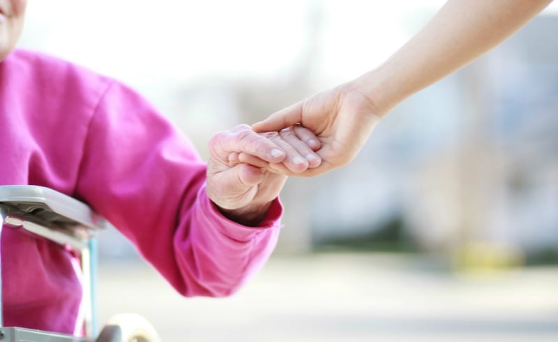a volunteer holding someone's hand