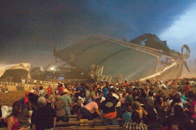 People are running after the stage of the concert has collapsed.