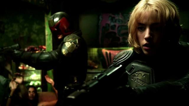 Karl Urban as Judge Dredd and Olivia Thirlby as Judge Anderson pointing guns in Dredd