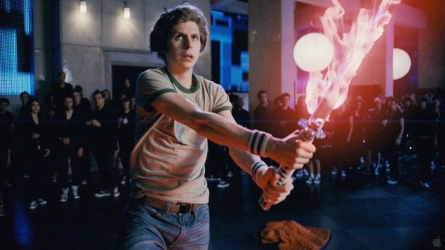Michael Cera holds a flaming sword in front of a crowd in Scott Pilgrim vs. the World