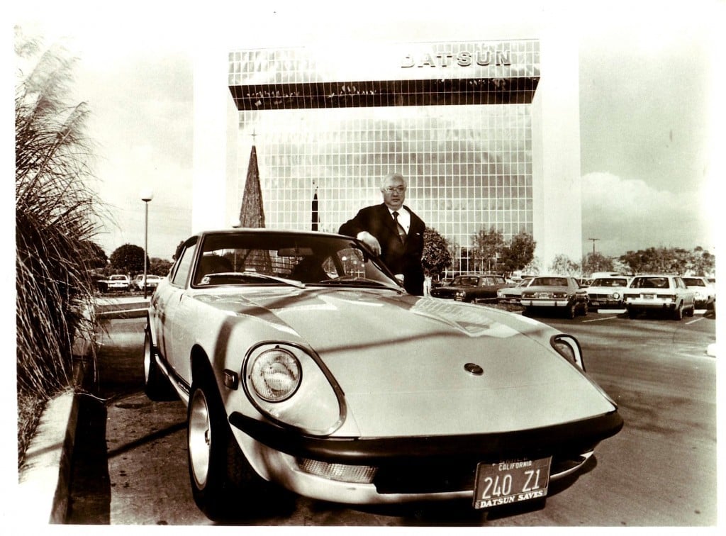 A vintage photograph of Yutaka Katayama posing with a Datsun 240Z.
