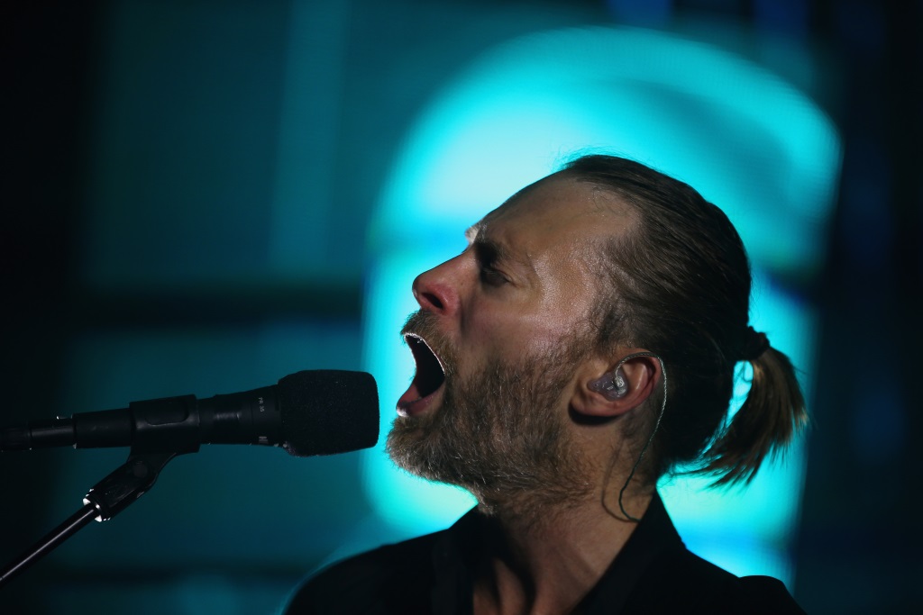 Thom Yorke sings into a microphone