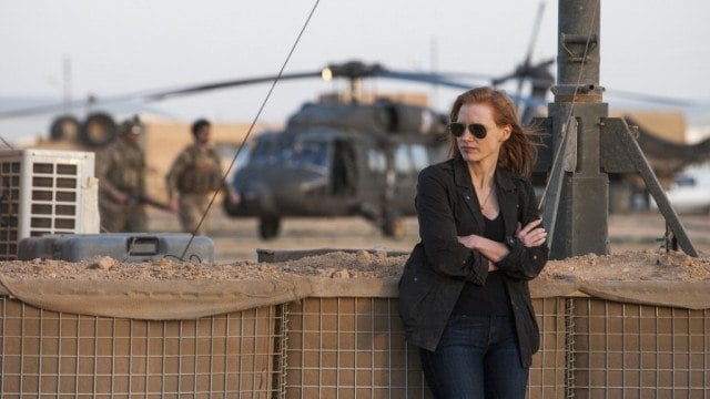 Jessica Chastain folds her arms and leans against a wall in 'Zero Dark Thirty.'