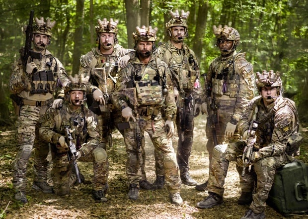 A group of soldier pose in the woods in History's Six