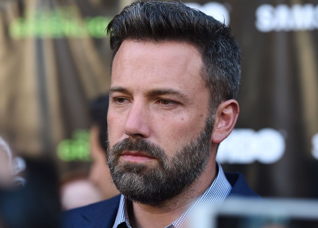 Ben Affleck is in a blue shirt and jacket on the red carpet.