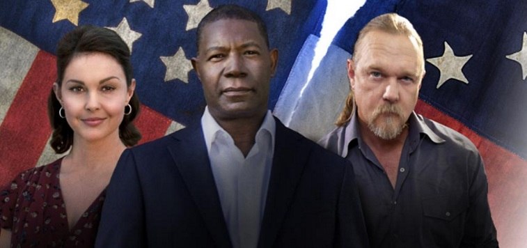 Ashley Judd, Trace Adkins, and Dennis Haysbert stare at the camera in front of a ripped American flag