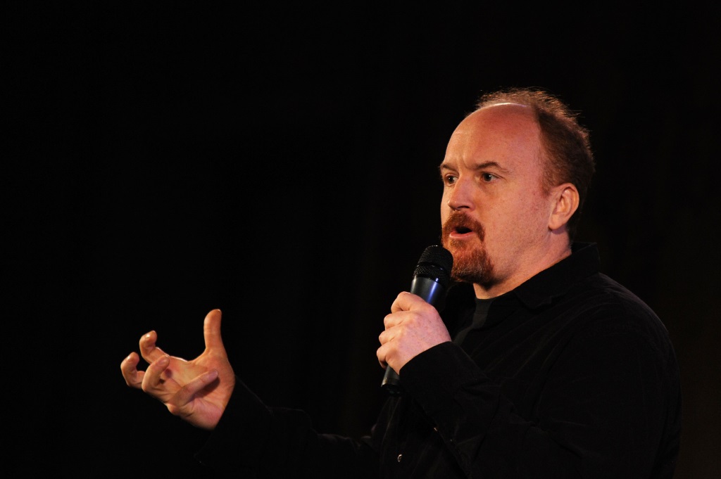 Louis C.K. is talking on stage.