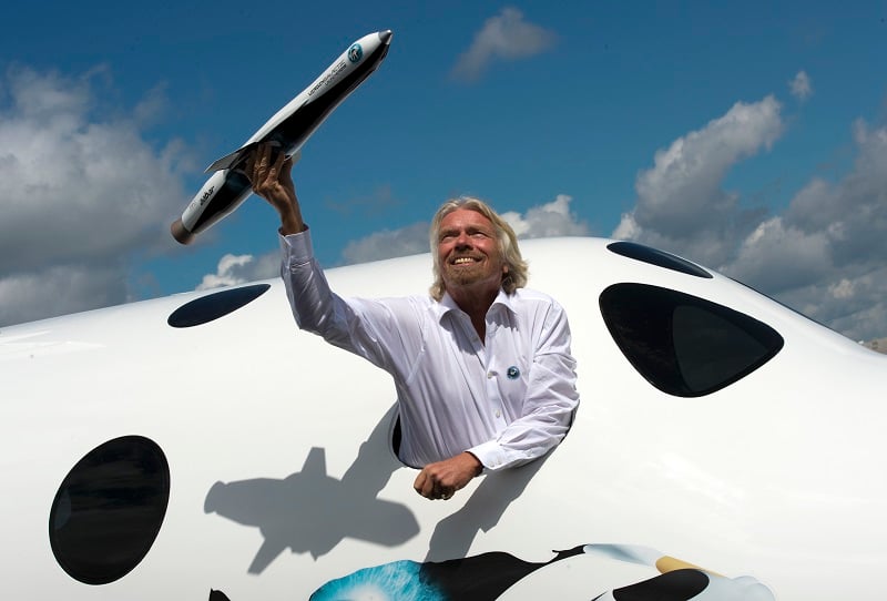 British billionaire Richard Branson poses for photographs in the window of a replica of the Virgin Galactic, the world?s first commercial spaceline.