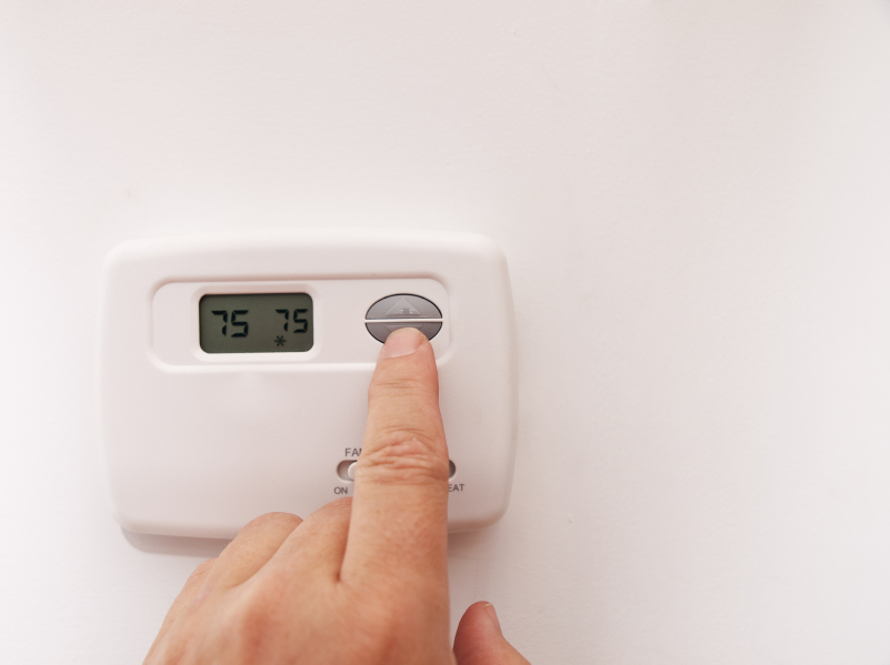 changing the temperature on a house thermostat