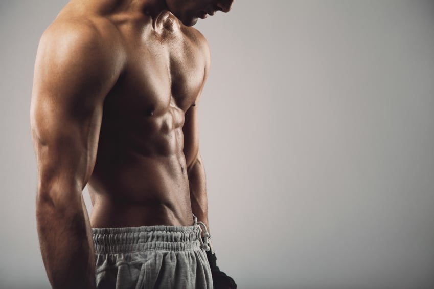 a clean shaven man posing, six pack abs