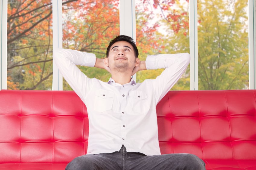 man sitting on a couch, thinking