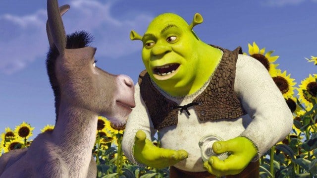 Donkey and Shrek have a conversation in a sunflower field. 