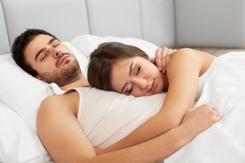 A couple laying in bed together